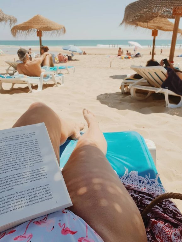 Na sua mala de praia vai um livro para ler durante o dia 